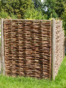 Braided wicker fence as a privacy screen Braided wicker fence as a privacy screen
