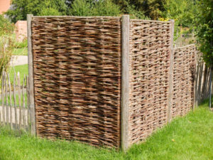 Braided wicker fence as a privacy screen Braided wicker fence as a privacy screen