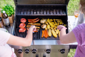 Two women are having a barbecue in the garden, barbecue Two women are having a barbecue in the garden, barbecue
