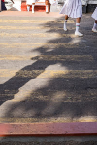 Legs of school children in uniform cross the street, crosswalk Legs of school children in uniform cross the street, crosswalk