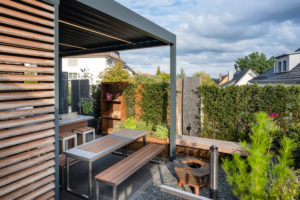 Modern covered terrace with seating and fireplace Modern covered terrace with seating and fireplace