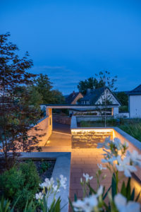 Entrance with access path in the evening with an atmospheric lighting concept Entrance with access path in the evening with an atmospheric lighting concept