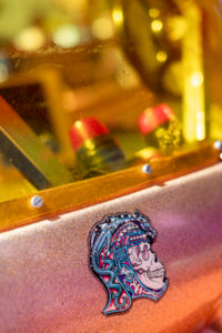 Detail of a colorful skull sticker on an old machine Detail of a colorful skull sticker on an old machine