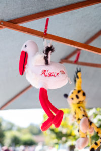 Stork soft toy hangs on a parasol for sale Stork soft toy hangs on a parasol for sale