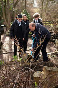 The Duke of Edinburgh plants a tree with volunteers during a visit to Railworld Wildlife Haven in Peterborough, Cambridgeshire.