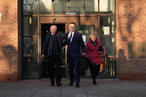 Bargain Hunt auctioneer Charles Hanson is accompanied by his parents as he leaves Derby Crown Court, after being cleared of causing assault occasioning actual bodily harm between May 13 and 17 2020 and engaging in controlling or coercive behaviour between May 2015 and June 2023, after police were called to reports of a domestic incident at his home in the village of Quarndon, Derbyshire in June 2023.