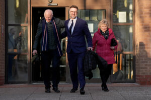 Bargain Hunt auctioneer Charles Hanson is accompanied by his parents as he leaves Derby Crown Court, after being cleared of causing assault occasioning actual bodily harm between May 13 and 17 2020 and engaging in controlling or coercive behaviour between May 2015 and June 2023, after police were called to reports of a domestic incident at his home in the village of Quarndon, Derbyshire in June 2023.