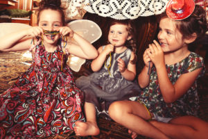 Party Girls eating sweet and sour candy spaghetti under the table Party Girls eating sweet and sour candy spaghetti under the table