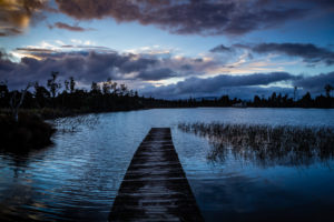 Evening mood and boardwalk on Lake Brunner, South Island New Zealand Evening mood and boardwalk on Lake Brunner, South Island New Zealand