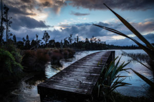 Evening mood and boardwalk on Lake Brunner, South Island New Zealand Evening mood and boardwalk on Lake Brunner, South Island New Zealand