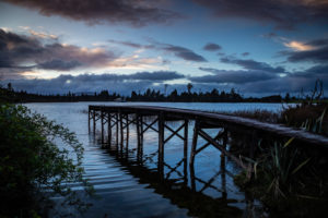 Evening mood and boardwalk on Lake Brunner, South Island New Zealand Evening mood and boardwalk on Lake Brunner, South Island New Zealand