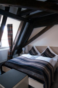 Double bed in room with half-timbered Double bed in room with half-timbered