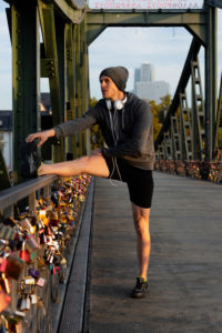 Sporty man stretching in the town, Frankfurt on the Main, Hessen, Germany Sporty man stretching in the town, Frankfurt on the Main, Hessen, Germany