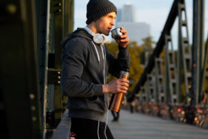 Sporty man has a break while jogging in the town, half portrait Sporty man has a break while jogging in the town, half portrait