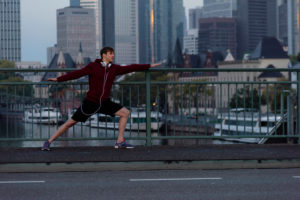 Sporty man stretching in the town, Frankfurt on the Main, Hessen, Germany Sporty man stretching in the town, Frankfurt on the Main, Hessen, Germany