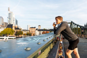Sporty man has a break jogging in the town, Frankfurt on the Main, Hessen, Germany Sporty man has a break jogging in the town, Frankfurt on the Main, Hessen, Germany