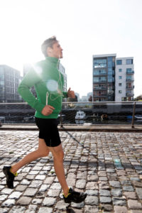 Sporty man jogging in the town, half portrait Sporty man jogging in the town, half portrait