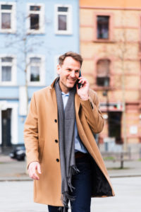 Businessman on the way to work with Smartphone, half portrait Businessman on the way to work with Smartphone, half portrait