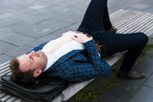 Businessman has a break on a park-bench Businessman has a break on a park-bench