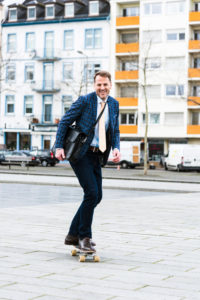 Businessman on the way to work by skateboard Businessman on the way to work by skateboard