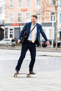 Businessman on the way to work by skateboard Businessman on the way to work by skateboard