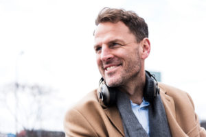 Businessman outside with earphones, portrait Businessman outside with earphones, portrait