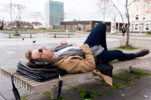 Businessman has a break on a park-bench Businessman has a break on a park-bench