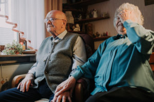 older couple, home, woman smiles