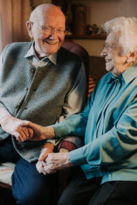 older couple holding hands, happy, laugh, 