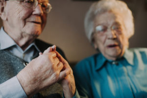 older couple holding hands, 