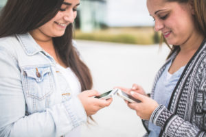 Zwei Jugendliche mit Smartphones unterwegs Zwei Jugendliche mit Smartphones unterwegs