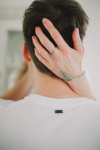 Young man embraces young woman, back view
