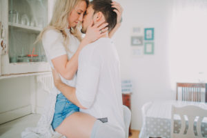 Young couple in love in the kitchen, half profile