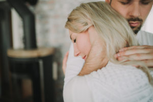 Young man embraces young woman, profile
