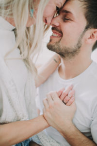 Young man embraces young woman, profile