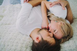 Young couple in love at home in the bed, portrait 