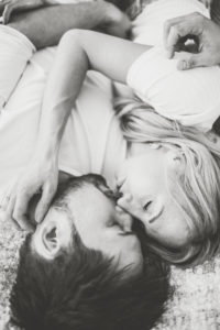 Young couple in love at home in the bed, half portrait, b/w
