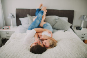 Young couple in love at home in the bed