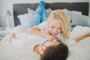Young couple in love at home in the bed