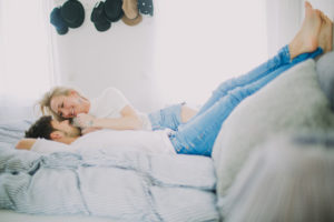 Young couple in love at home in bed