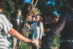 Alternate bridal couple at wedding ceremony outdoors, portrait 