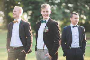 Bridegroom and groomsman outside, half portrait