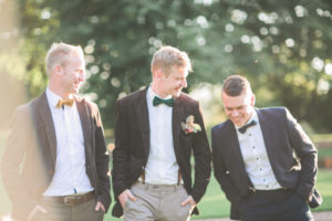 Bridegroom and groomsman outside, half portrait