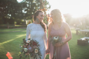 Bride and witness at alternative wedding outside, half portrait