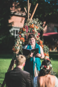 Alternate bridal couple at spiritual wedding ceremony outdoors 