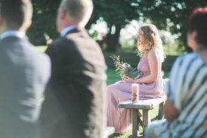Guests and witness at alternative wedding outside, half profile