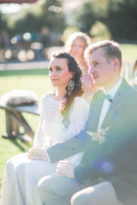 Alternate bridal couple at wedding ceremony outdoors 