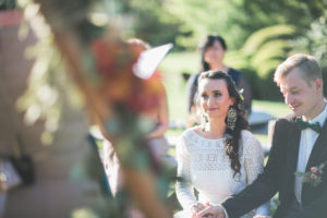 Alternate bridal couple at wedding ceremony outdoors, portrait 
