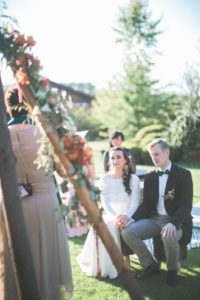 Alternate bridal couple at wedding ceremony outdoors