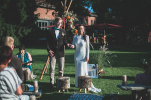 Alternate bridal couple at spiritual wedding ceremony outdoors